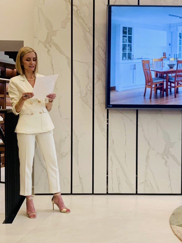 Katie Malik giving speech at 10th anniversary party