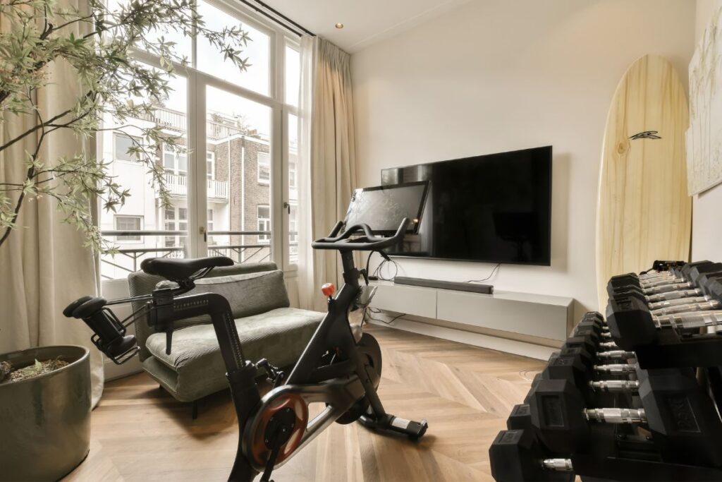Small home gym design in London flat with wall-mounted storage and fold-away equipment