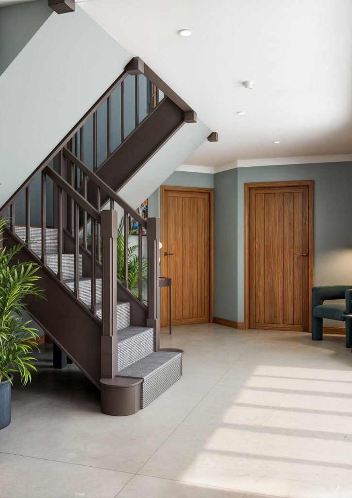 3D interior design visualisation of a modern entrance hallway featuring a dark painted staircase with a textured runner, large format floor tiles, and contemporary oak doors in a Hertfordshire country house.